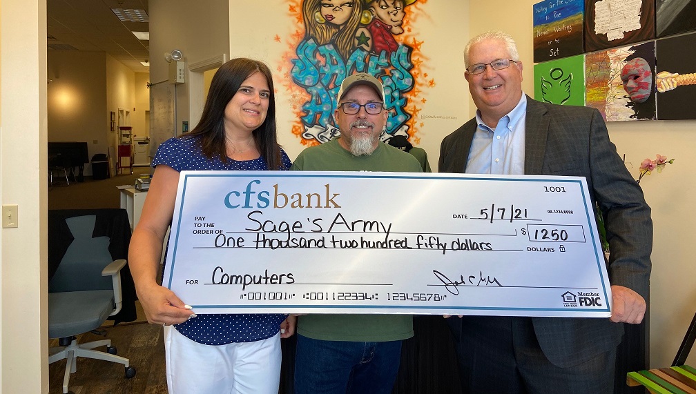 Picture of cfsbank employees making a donation to Sage's Army 